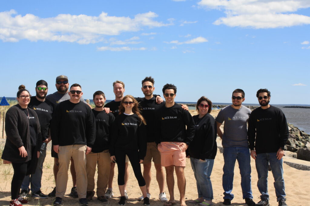 Photo of the team in ACE Solar sweatshirts on Salisbury Beach
